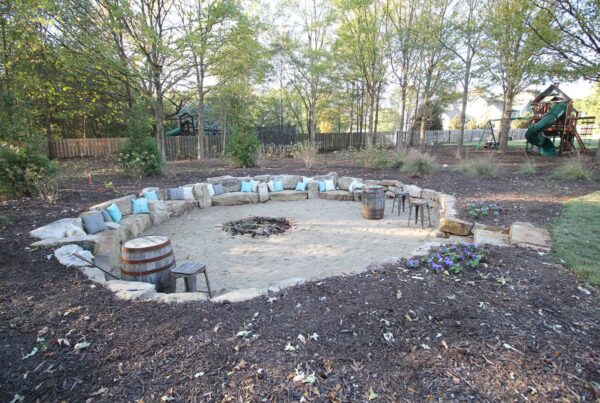 Stone fire-pit gathering area in Executive Green’s Treiber project